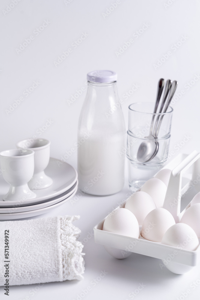 fresh white eggs, milk bottle on white background. Front view, copy space, selective focus. fresh white eggs, milk bottle on white background. Front view, copy space, selective focus.