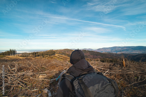 Картината върху платно Tourist with a backpack on his back shows a younger inexperienced hiker which way to go and where today's destination is