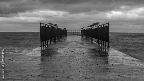 stormy wave crashing on the beach against the stormy sky
