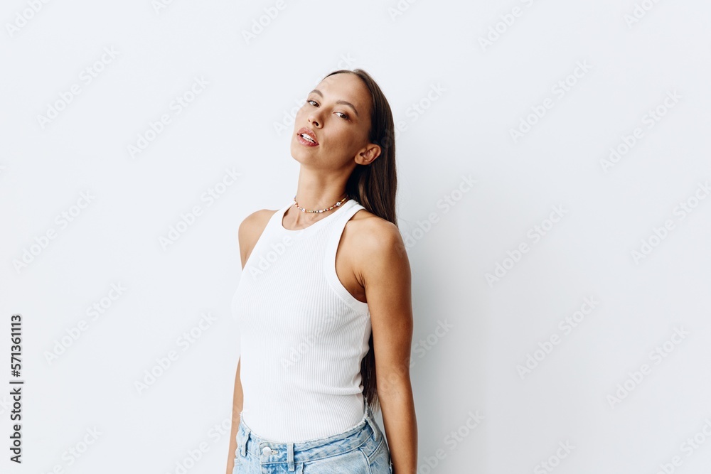 Portrait of a young beautiful woman with tanned skin model on a white background in a white T-shirt with a chain around her neck with a beautiful smile Portrait of a young beautiful woman with tanned skin model on a white background in a white T-shirt with a chain around her neck with a beautiful smile