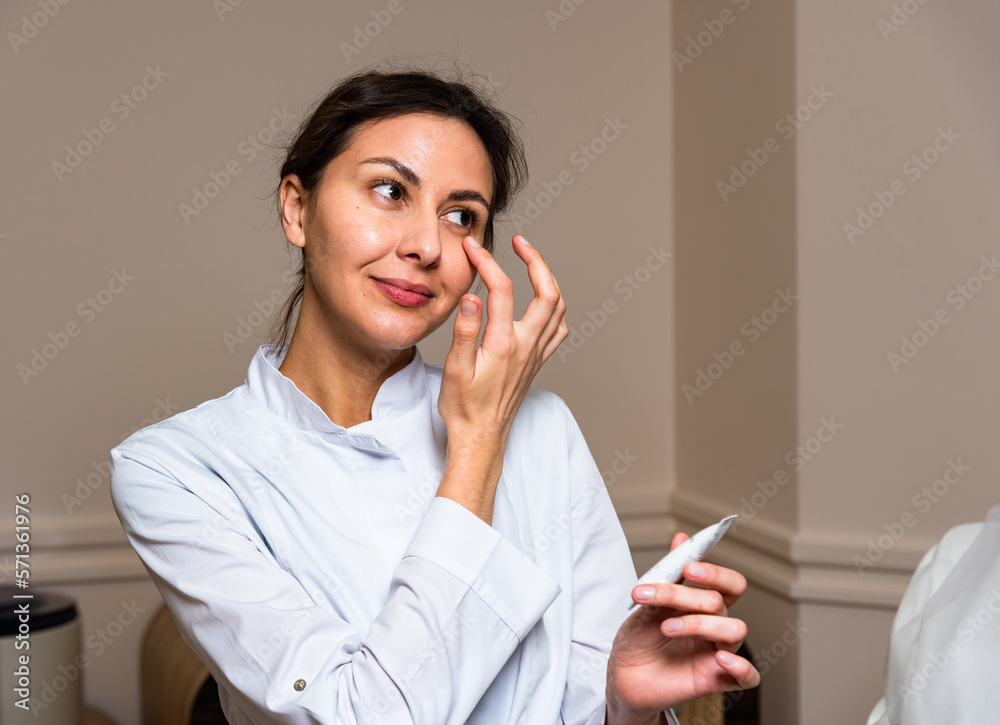 A young girl takes care of her facial skin with the help of medical preparations A young girl takes care of her facial skin with the help of medical preparations