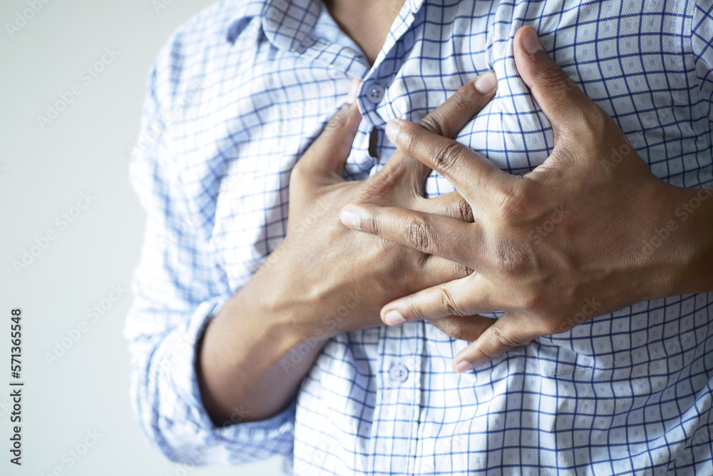 young man suffering pain in heart and holding chest with hand young man suffering pain in heart and holding chest with hand