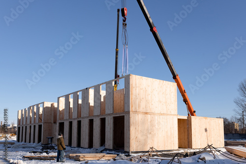 The construction process of a new and modern modular house made of composite sip panels on a sunny winter day. photo