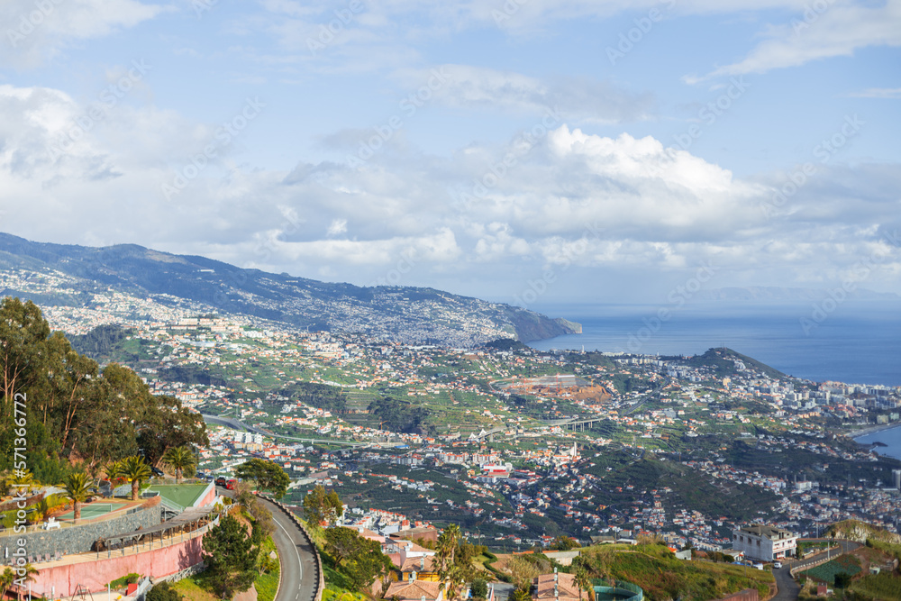 Amazing city of Funchal on the island of Madeira near the ocean, panoramic view. The mountain and the houses with cloudy sky