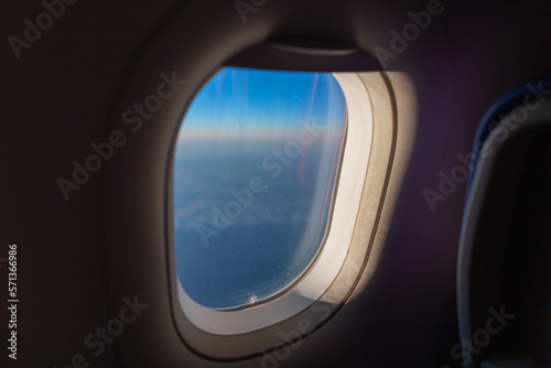 Porthole window in an airplane. Airplane flying  travel