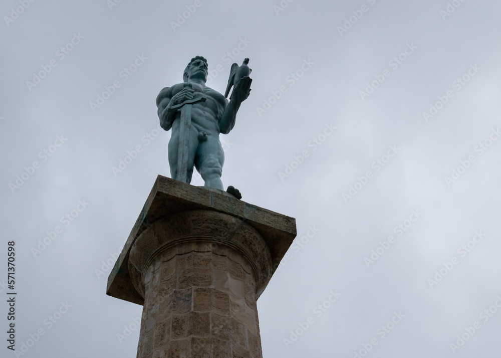Fototapeta premium Victor statue at Belgrade park Kalemegdan close up against overcast sky