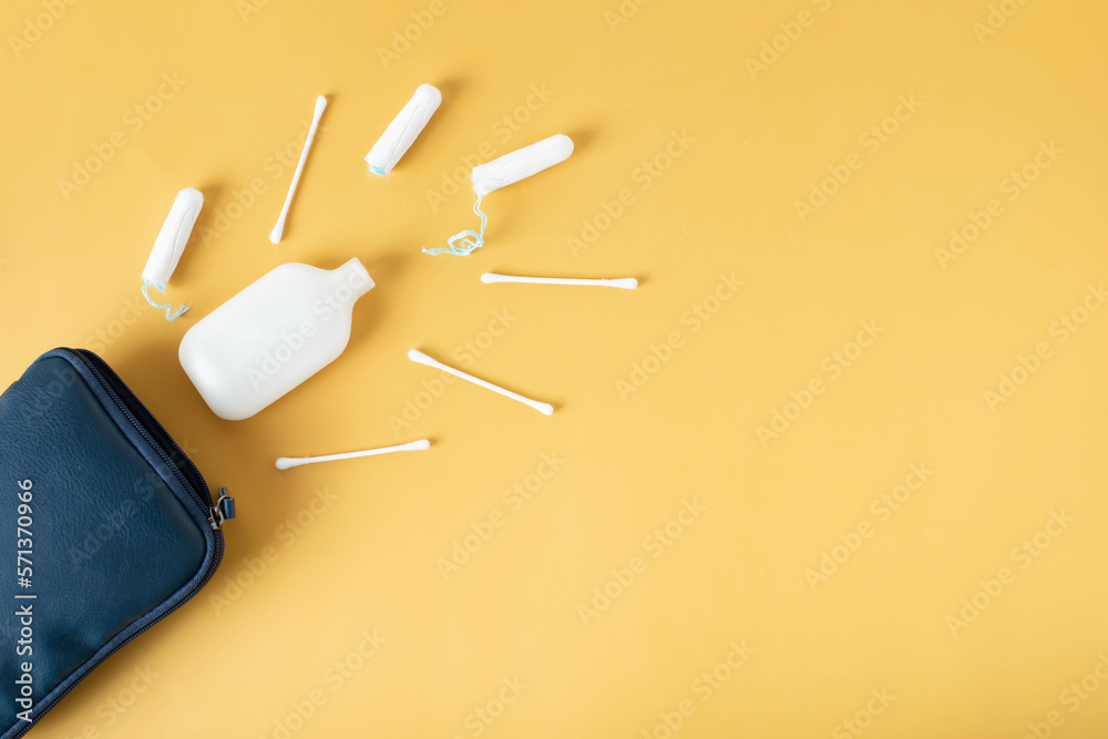 cosmetic bag for travel on a yellow background, feminine hygiene products cosmetic bag for travel on a yellow background, feminine hygiene products
