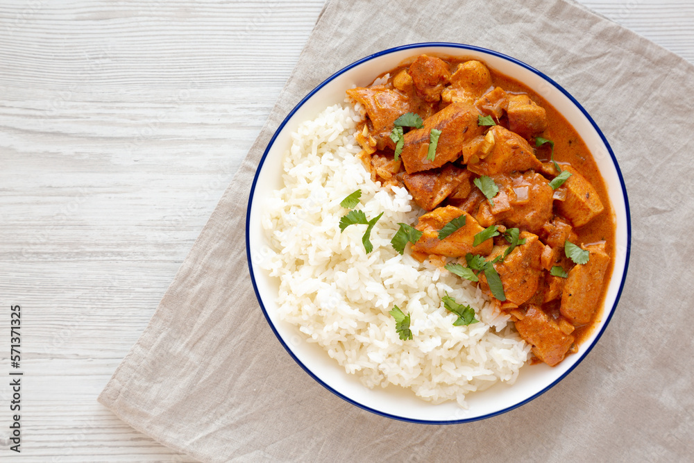 Homemade Easy Indian Butter Chicken with Rice on a Plate, top view. Flat lay, overhead, from above. Copy space. Homemade Easy Indian Butter Chicken with Rice on a Plate, top view. Flat lay, overhead, from above. Copy space.