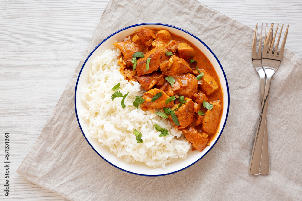 Homemade Easy Indian Butter Chicken with Rice on a Plate, top view. Flat lay, overhead, from above. Homemade Easy Indian Butter Chicken with Rice on a Plate, top view. Flat lay, overhead, from above.