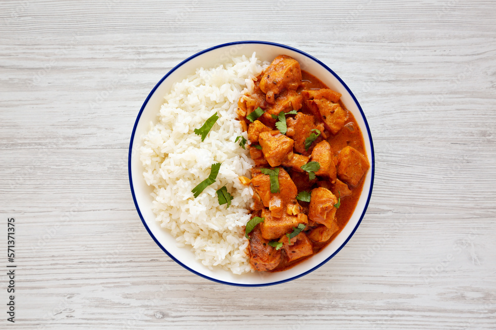 Homemade Easy Indian Butter Chicken with Rice on a Plate, top view. Flat lay, overhead, from above. Homemade Easy Indian Butter Chicken with Rice on a Plate, top view. Flat lay, overhead, from above.