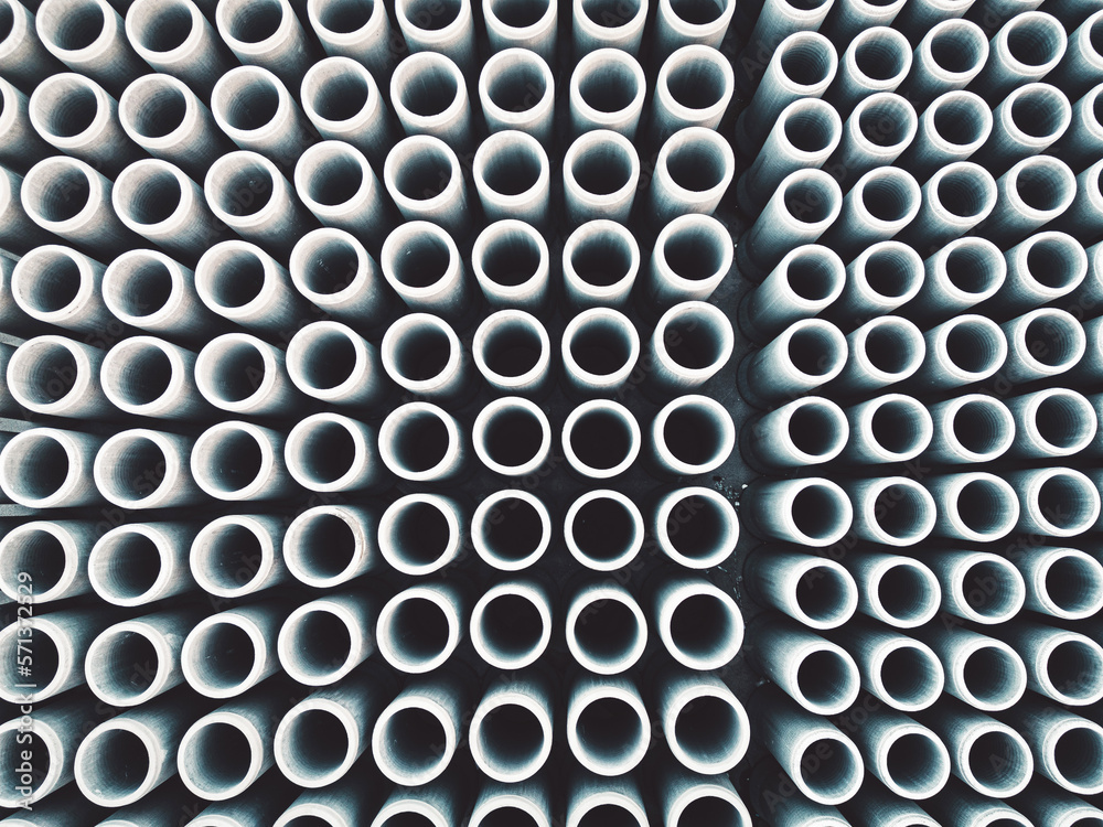 Top down view of round concrete pipes or pillars stacked in rows at the construction firm base Top down view of round concrete pipes or pillars stacked in rows at the construction firm base