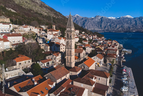 Perast, Montenegro, beautiful aerial top panoramic view of Perast old town with st. Nikola church, with Adriatic sea, bay of Kotor, Dinaric Alps mountains in sunny day © tsuguliev