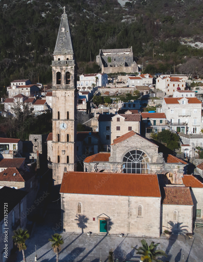 Perast, Montenegro, beautiful aerial top panoramic view of Perast old town with st. Nikola church, with Adriatic sea, bay of Kotor, Dinaric Alps mountains in sunny day