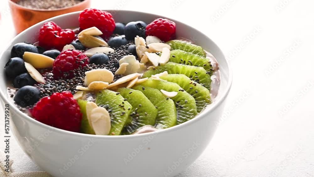 Delicious smoothie bowl with berries, kiwi, raspberries and chia seeds