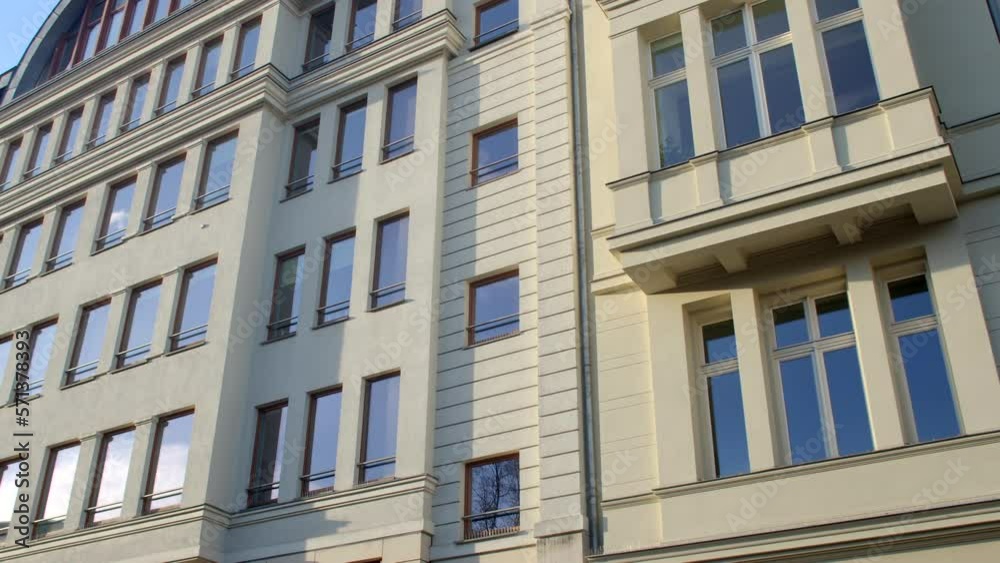 City building facade. Glass windows, concrete floors. Glare of the sky and the sun in the glass of apartments. Multi storey building.. City building facade. Glass windows, concrete floors. Glare of the sky and the sun in the glass of apartments. Multi storey building..