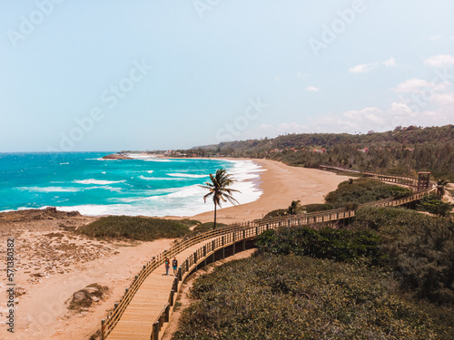 Large wooden bridge landscape with a field of sand in the beach and the ocean from puerto rico isabela west side photo