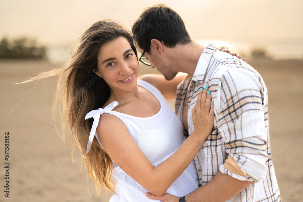 Portrait of beautiful pregnant woman embracing handsome man at beach. Portrait of beautiful pregnant woman embracing handsome man at beach.
