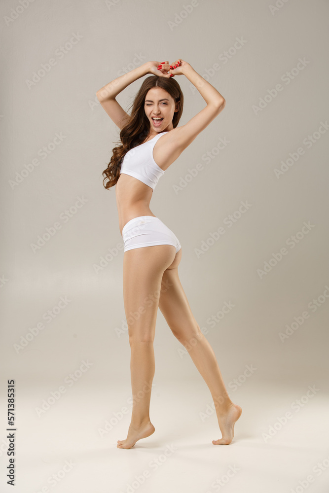 Woman with natural slim tanned body in underwear