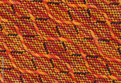 Close-up handwoven wavy pattern in black, orange and red.