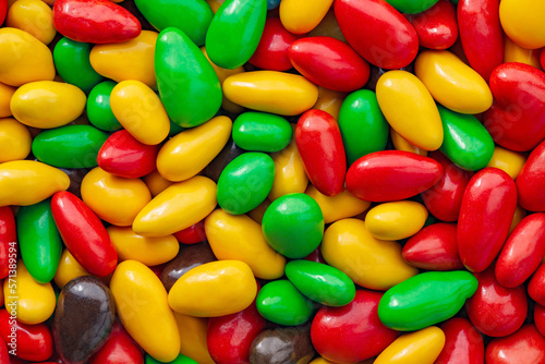 Candy seeds in multi colored sweet glaze in bulk, close-up, wallpaper background, full depth of field.