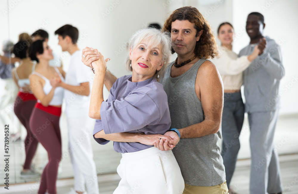 Obraz premium Caucasian man and mature woman rehearsing latin paired dance moves
