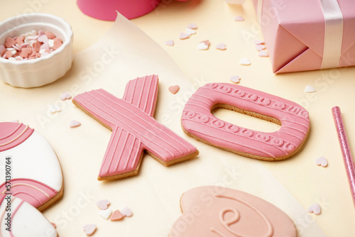 Sweet cookies and sprinkles on color background, closeup. Valentine's Day celebration