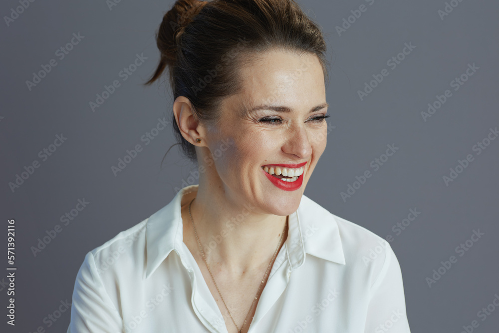 happy young female employee against grey background happy young female employee against grey background