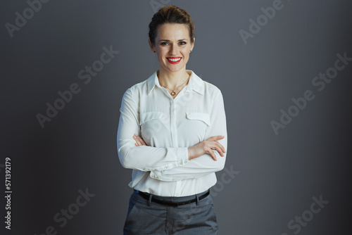 happy trendy female worker against grey background