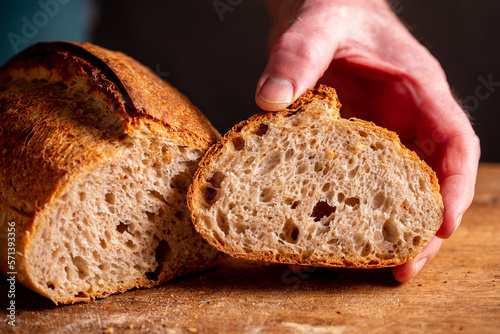 man cutting homemade bread