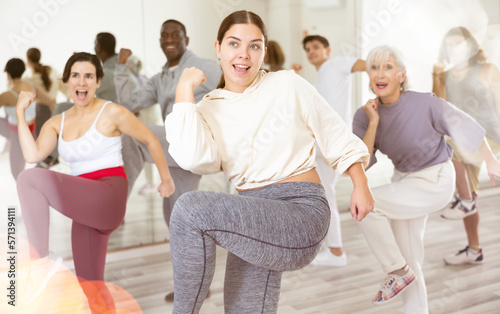 Group of people of different nationalities, engaged in a dance studio, learn sports dance in lesson