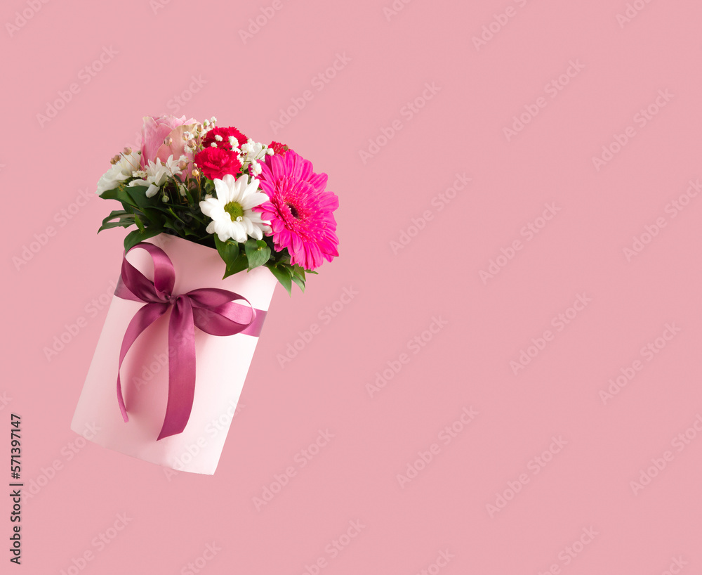 Fototapeta premium Pink gift box with various flowers on pink background. Valentines day aesthetic nature concept. 8 March card idea. Copy space.