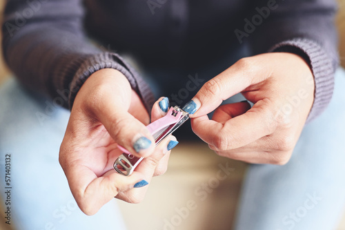 cut nails concept, woman hand holding nail clipper and cutting nails hand - fingernail health care