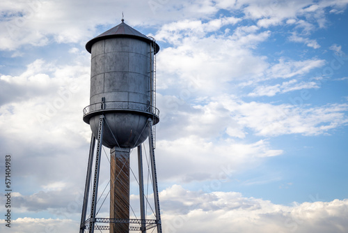Silver Antique Water Tower Against a Partially Cloudy Sky