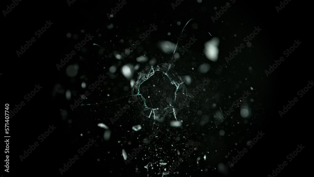 Super Slow Motion Shot of Real Bullet Hole Glass Break Isolated on Black Background at 1000fps.