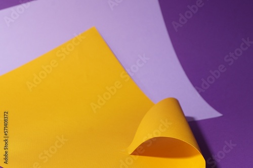 Different colorful paper sheets on purple background