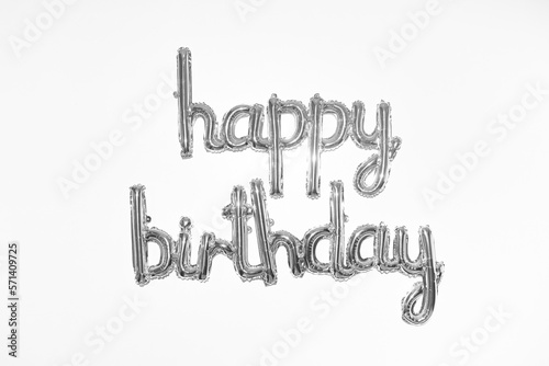 Photography Silver happy birthday balloon lettering on a white wall