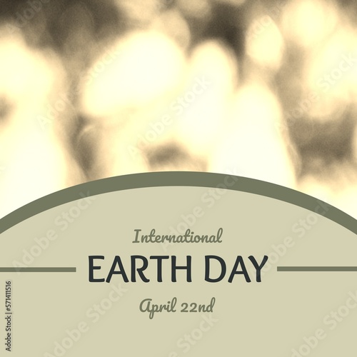 Composite of international earth day and april 22nd text in gray curve over defocused lens flare