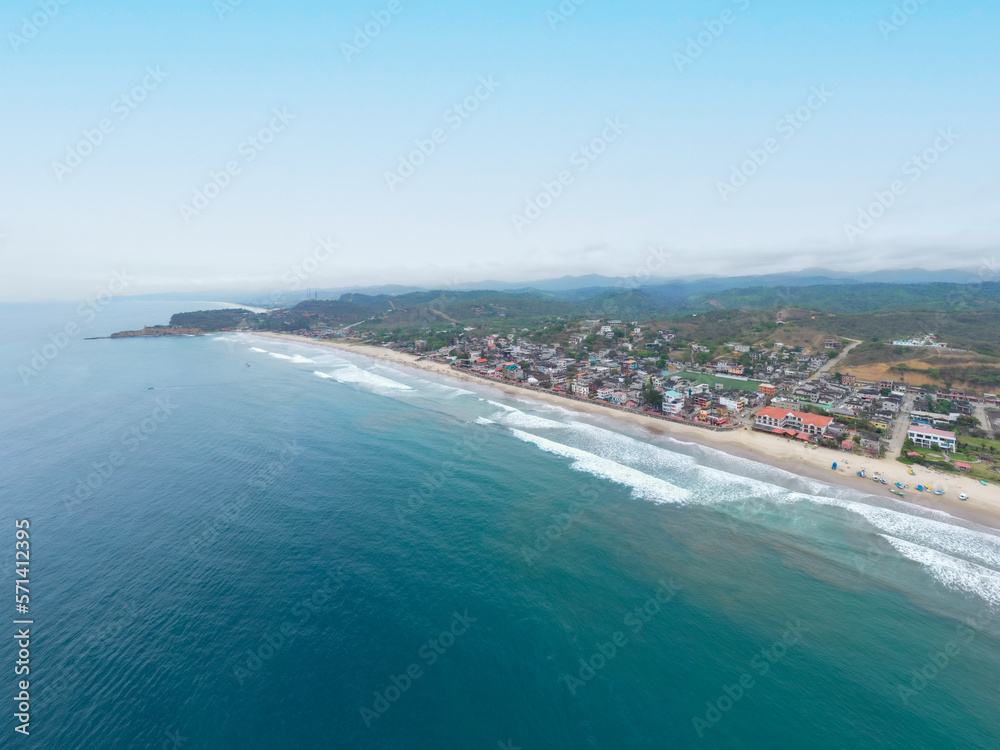 Aerial view of Montanita, a famous tourist destination on the coast of Ecuador with bright blue ocean water, high waves and loads of parties