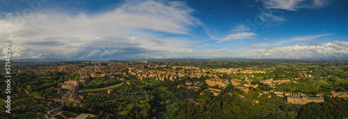 Scenery of Siena, a beautiful medieval town in Tuscany, view of the Dome and Bell Tower of Siena Cathedral, landmark Mangia Tower and Basilica of San Domenico,Italy. Aerial drone shot, october 2022