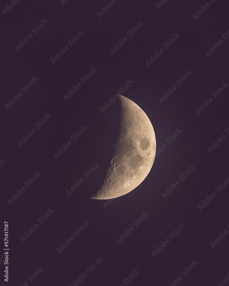 Waxing crescent moon in a clear blue night sky - Detailed close up with craters Waxing crescent moon in a clear blue night sky - Detailed close up with craters