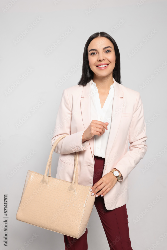 Young woman with stylish bag on white background Young woman with stylish bag on white background