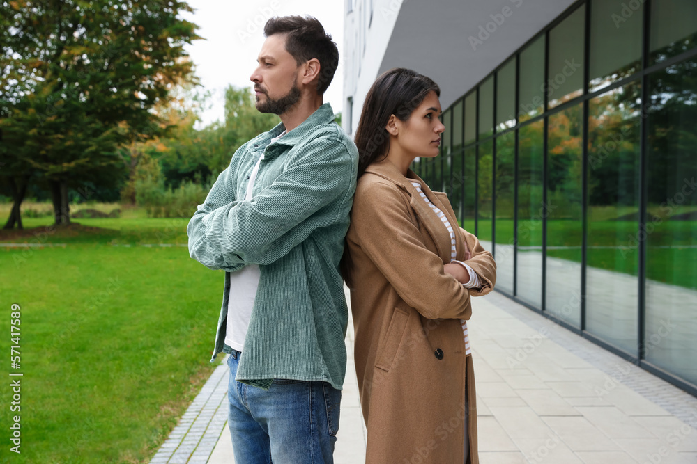 Fototapeta premium Upset arguing couple near building outdoors. Relationship problems