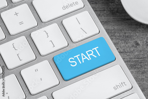 Light blue button with word Start on computer keyboard, closeup