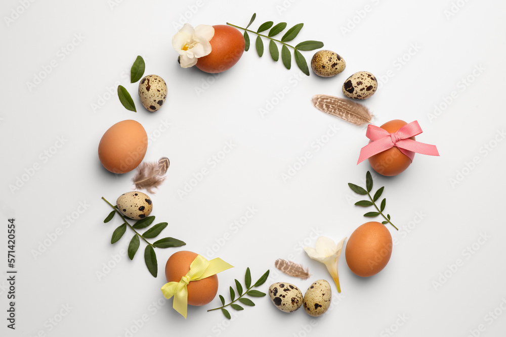 Frame of Easter eggs, twigs and flowers on white background. Space for text