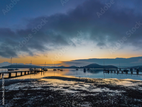 Soft and hazy aerial sunrise waterscape with boats