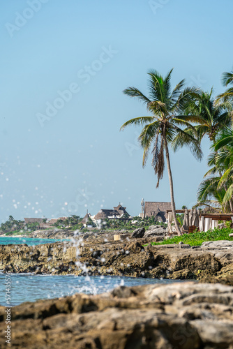 Waves crash on the rocky Caribbean coast in Tulum, Mexico.