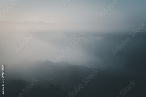 Beautiful sunrise over foggy forest