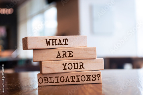 Obraz na plátne Wooden blocks with words 'What are your obligations?'.