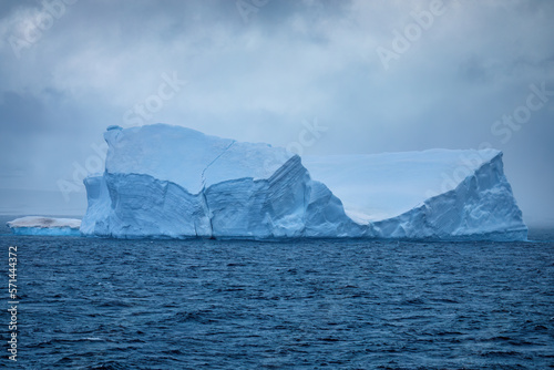 Icebergs floating on the open sea in Antarctica reflecting their blue color in daylight