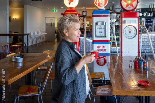 Women drinking coffee at the old fashion gas station cafe. photo